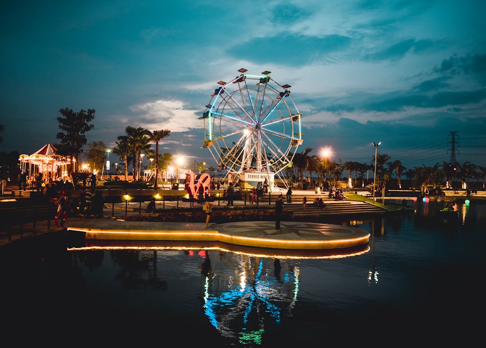 calm body of water near ferris wheel