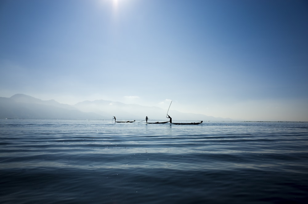 calm body water under blue sky