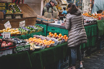 woman in front of fruit stands in market