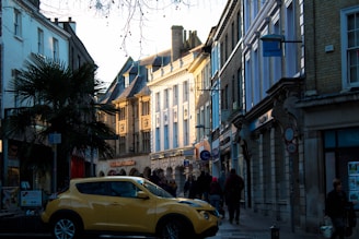 A docent leading a small group through the colorful streets of Ybor City, pointing out historic buildings and sharing local tales.