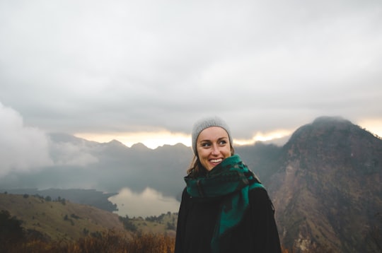 woman wearing green scarf smiling in Mount Rinjani Indonesia