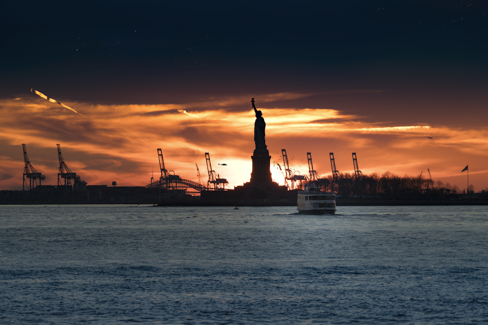 silhouette of Statue of Liberty near body of water