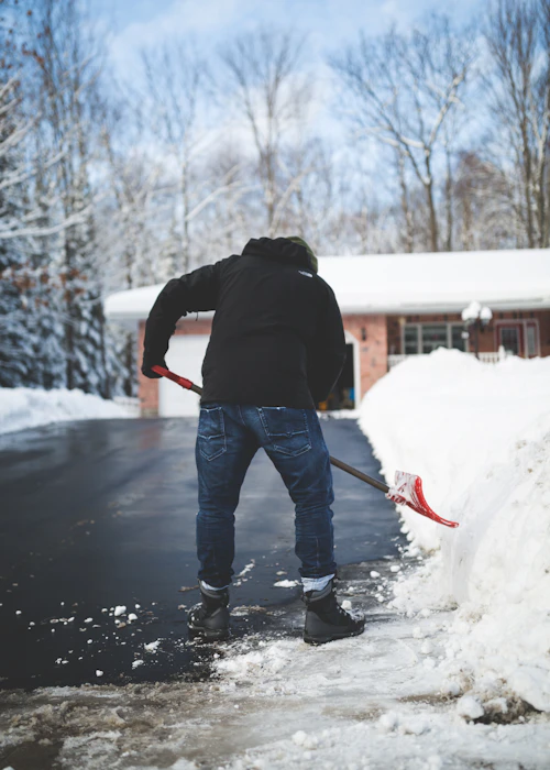Shoveling snow from a residential driveway in Goderich, Ontario