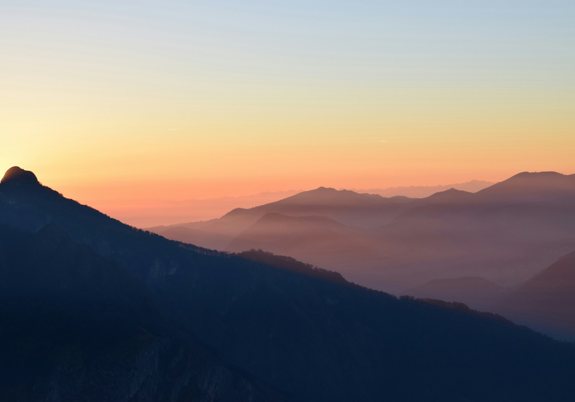A sweeping panoramic shot of a serene mountain landscape, filmed during golden hour to capture rich colors and depth.