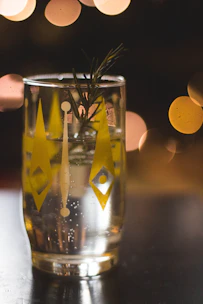 A bright, fizzy adaptogenic beverage in a chilled glass, bubbles rising invitingly.