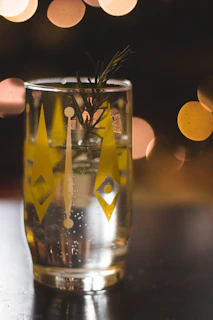 Close-up of a glass filled with golden herbafizz, bubbles rising gently against a soft natural background.