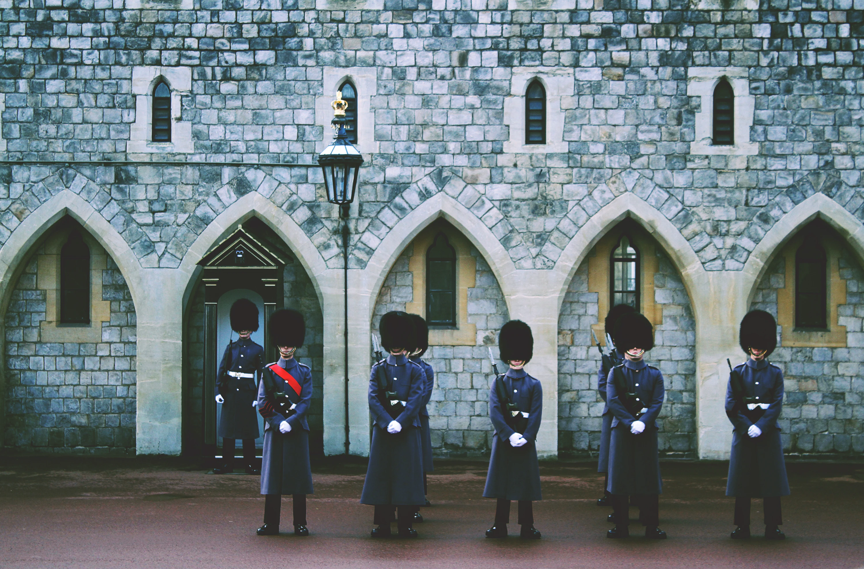 A tightly cropped view of royal guards at Windsor, their bearskin hats and white gloves in monochrome.