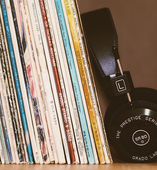 wireless headphones leaning on books