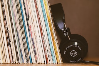 wireless headphones leaning on books