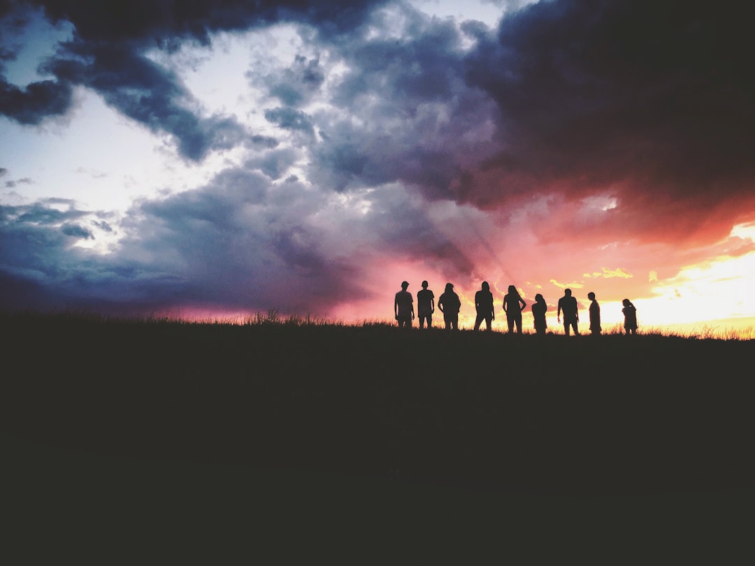 silhouette of nine persons standing on the hill, SILHOUETTE SKY