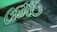 A neon sign with the word 'Court' in vibrant green light is mounted on an industrial ceiling. The background includes exposed metal beams and a partially visible suspended lamp, creating an urban and modern atmosphere.