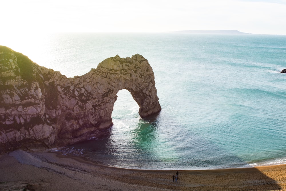 aerial view of beach with arch rock formation