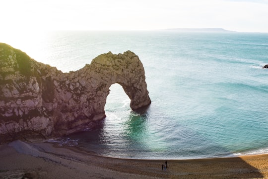 aerial view of beach with arch rock formation in Durdle Door United Kingdom