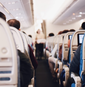 shallow focus photography of people inside of passenger plane