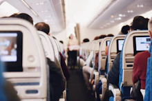 Rows of airplane seats inside a passenger cabin