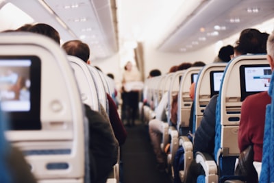 shallow focus photography of people inside of passenger plane plane zoom background