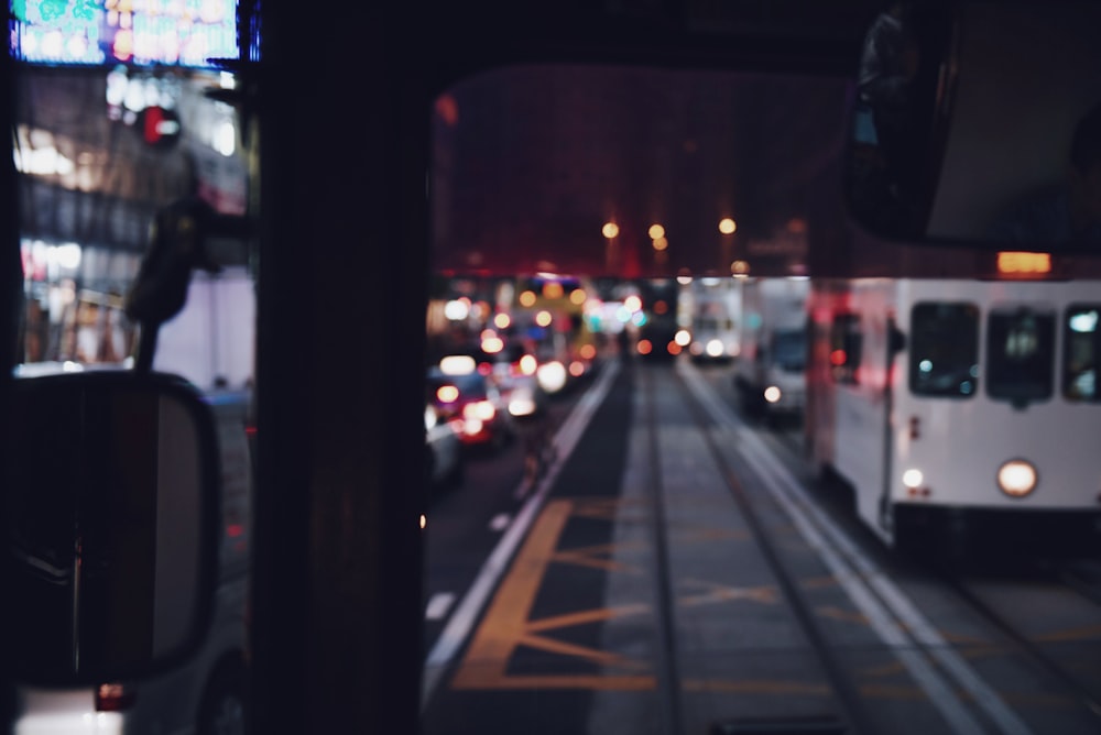 bokeh photgraphy of vehicles traveling on road at night