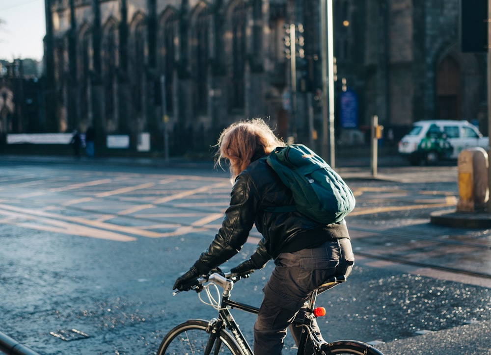 man riding on commuter bicycle