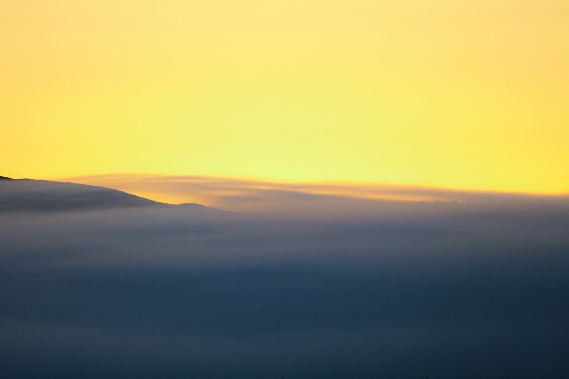 a plane flying in the sky above the clouds