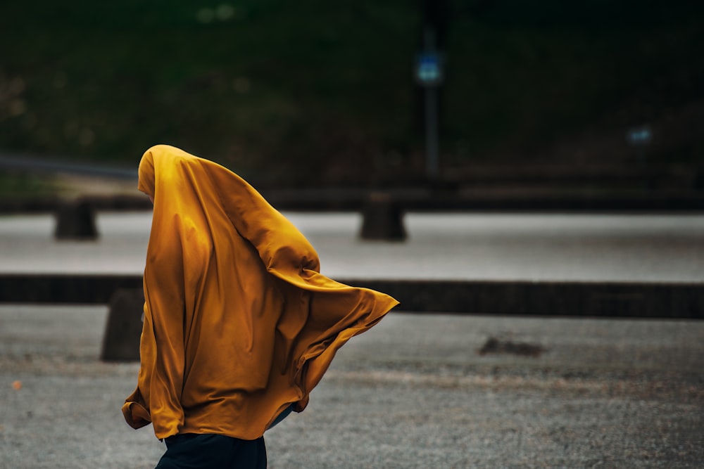 person wearing yellow jacket