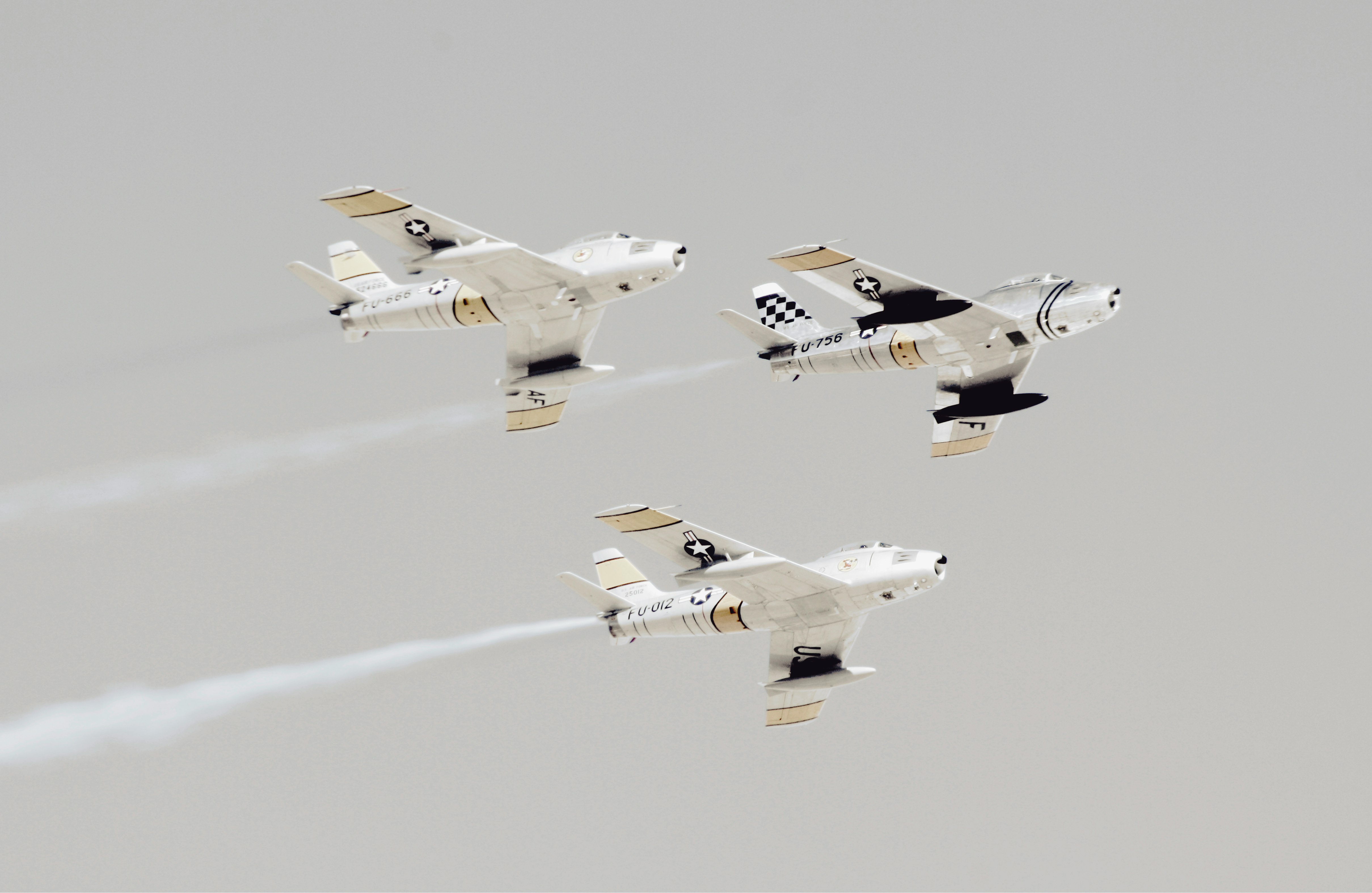three white-and-black jet planes
