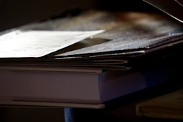 Stack of academic journals with highlighted research papers.