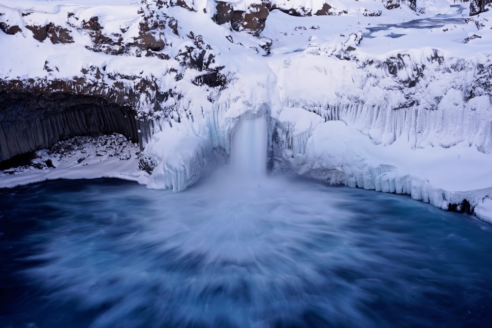 body of water across snow mountain