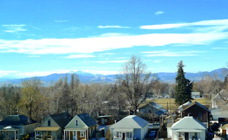 A serene neighborhood street in Medicine Hat, Alberta, lined with charming houses under a clear blue sky.