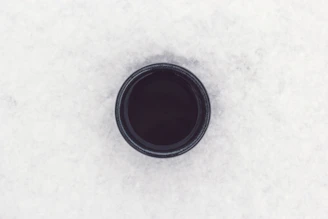 round black container on top of white surface