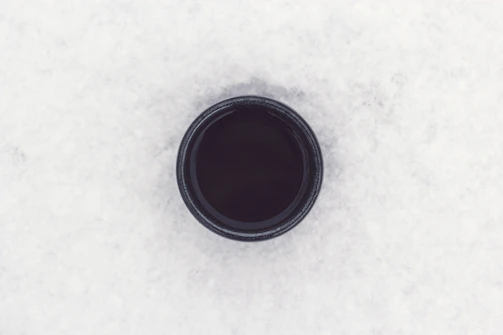 round black container on top of white surface
