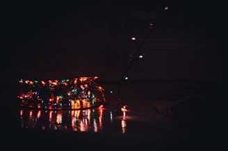 A cozy living room softly illuminated by colorful mini decorative lights and glow-in-the-dark wall stickers.