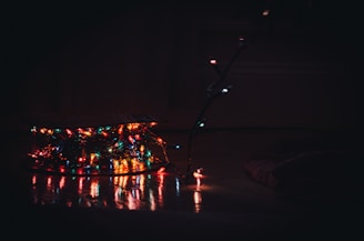 A mystical indoor studio glowing with warm, colorful lights and hanging crystals.