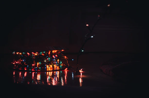 A cozy living room softly illuminated by colorful mini decorative lights and glow-in-the-dark wall stickers.