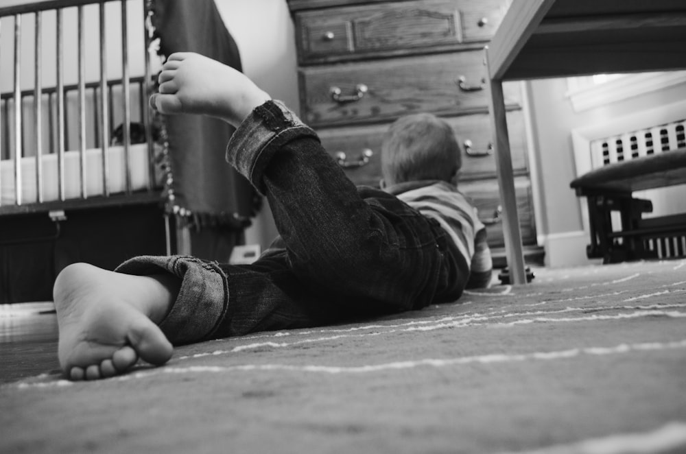 toddler lying on floor