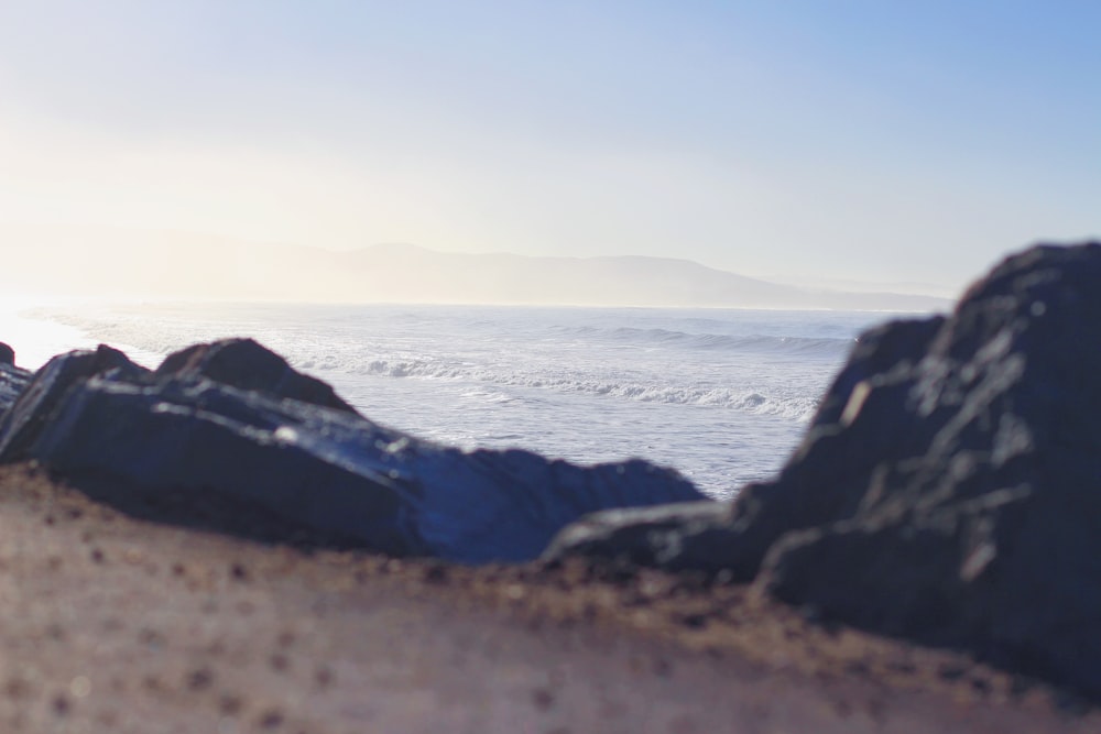 rock mountain near body of water