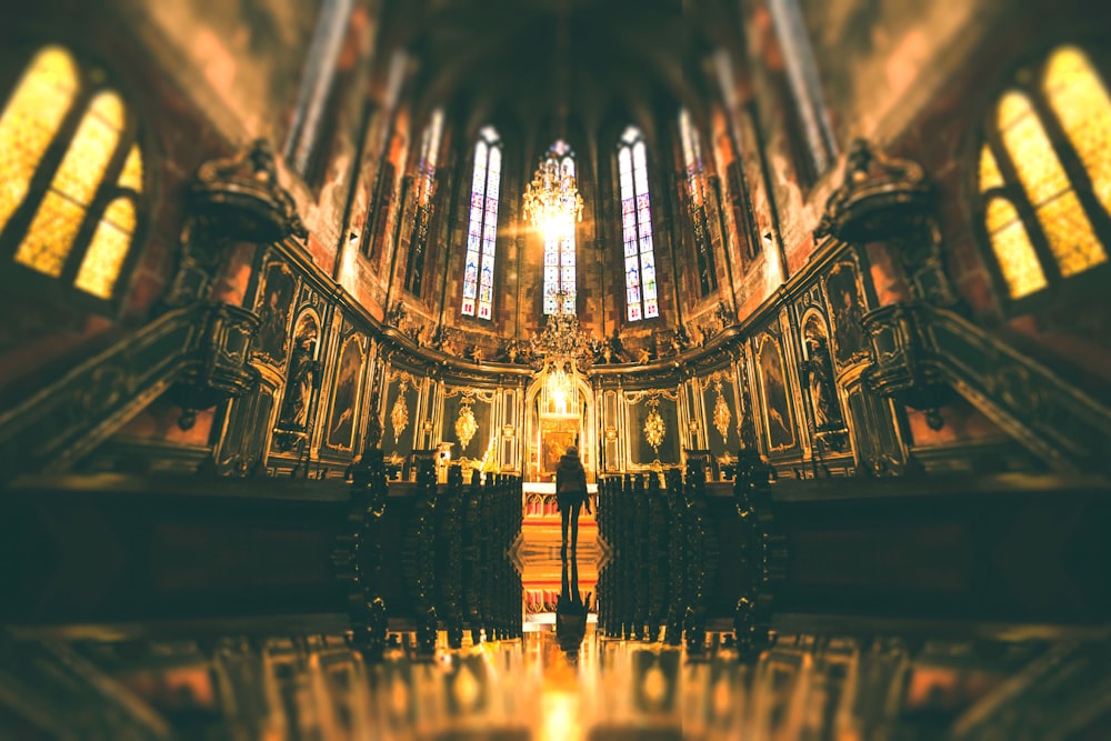 Gold lighting coming from the windows of a church.