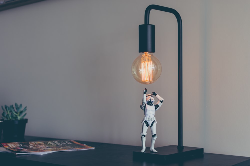 Storm Trooper vinyl figure under desk lamp