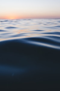 photo of calm sea water during daytime