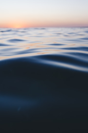 photo of calm sea water during daytime