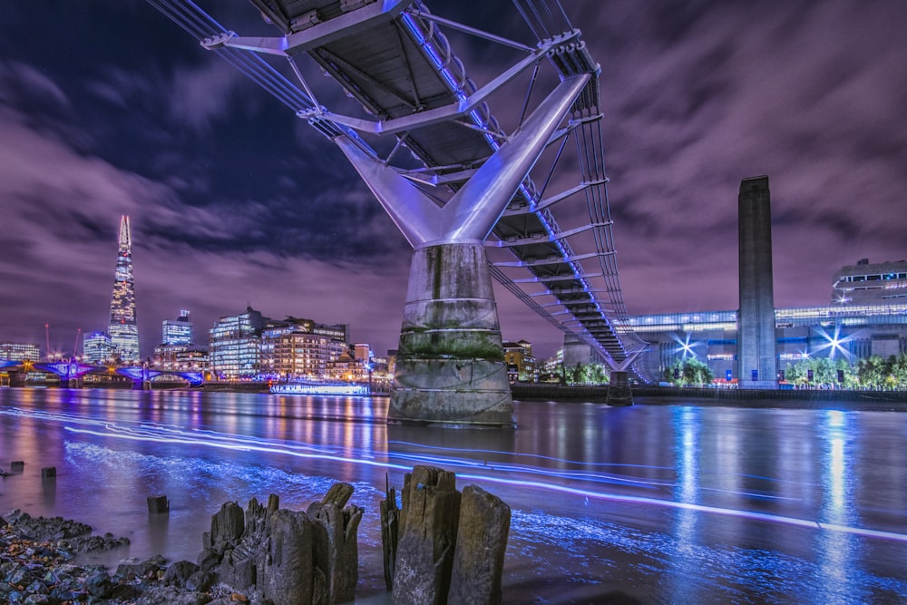 bridge over the river connected to city at night time