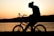 silhouette of man riding in bike
