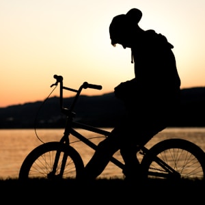 silhouette of man riding in bike