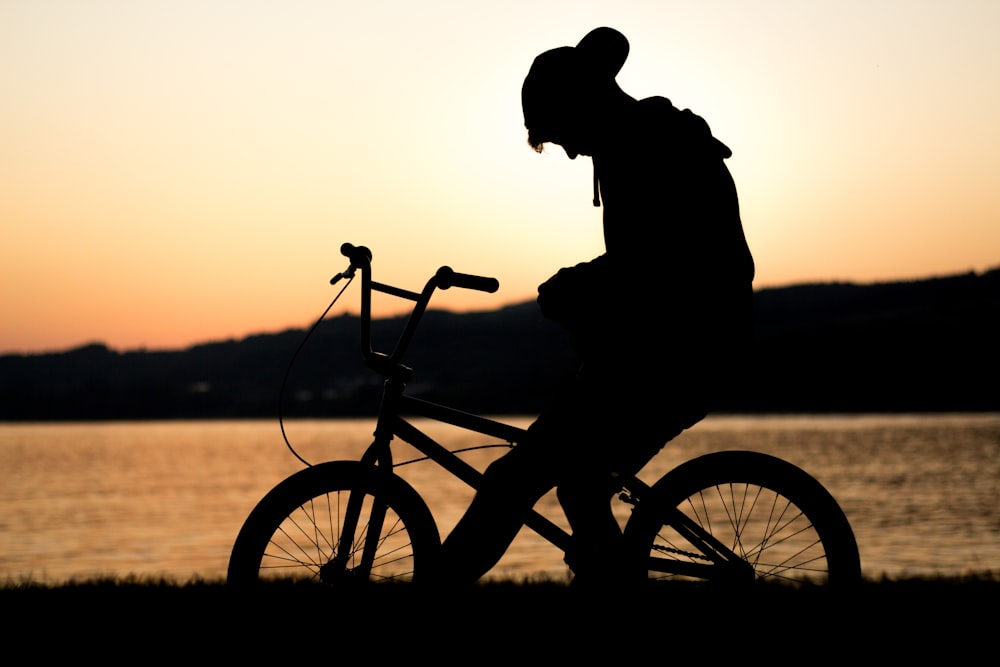 silhouette of man riding in bike