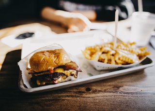 macro photography of burger and fries served on tray