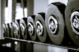 Bright and clear image of a set of dumbbells on a gym floor.