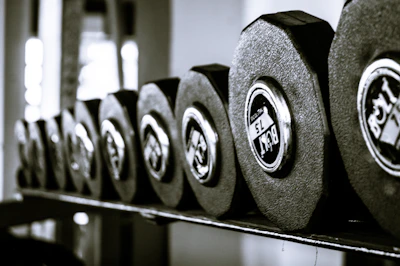 Bright and clear image of a set of dumbbells on a gym floor.