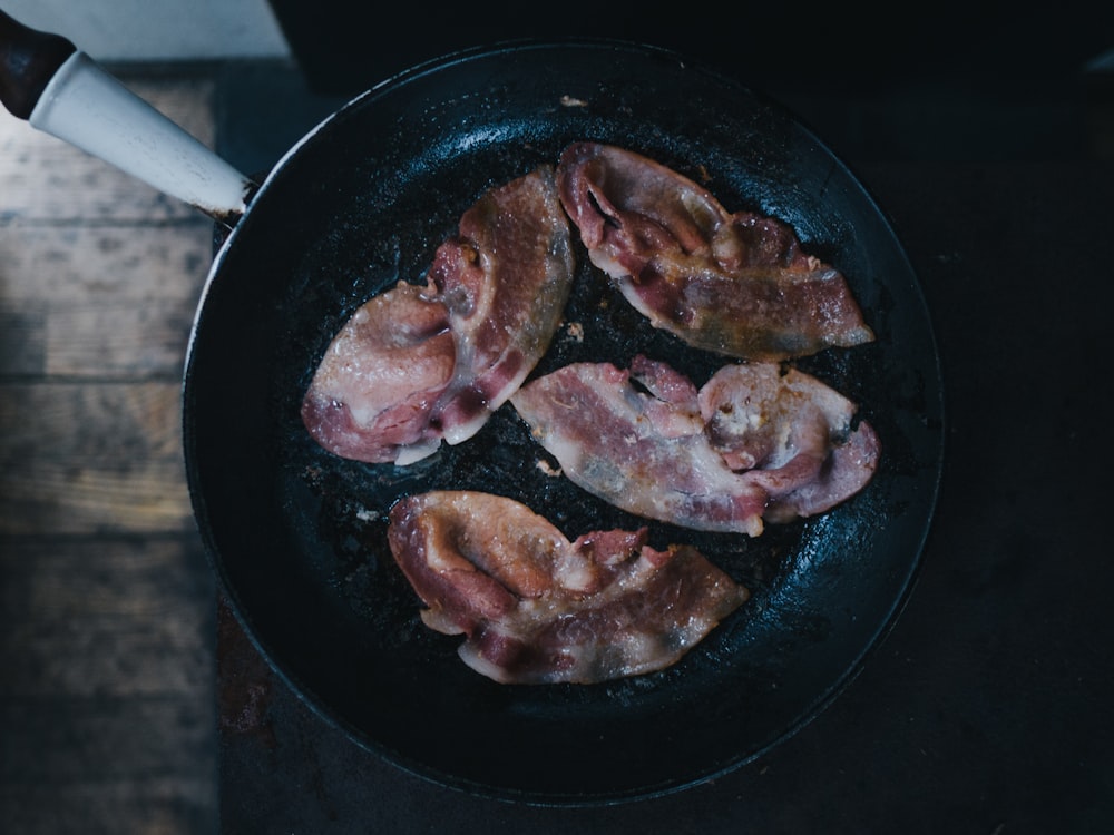 bacon on top of black cast-iron skillet