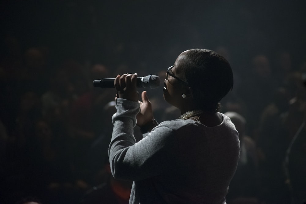 woman singing using microphone