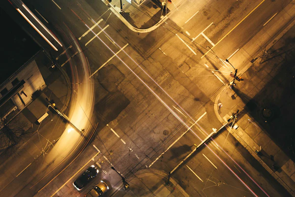 Aerial view of a 3-way T-junction road intersection at night