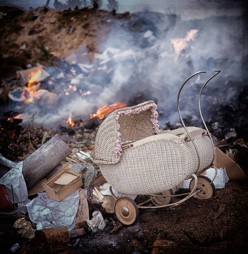 A baby carriage at a dump.